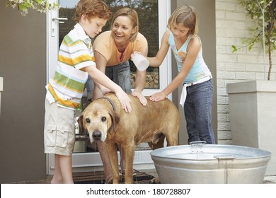 Happy Family Washing Their Dog