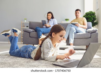 Happy Family Watching Together Video Online In A Laptop While Sitting Comfortably At Home.