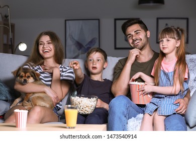 Happy Family Watching TV In Evening