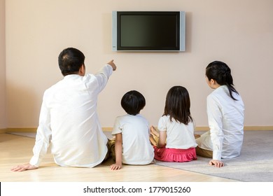 Happy Family Watching TV At Home