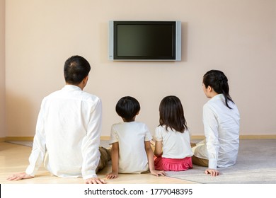 Happy Family Watching TV At Home