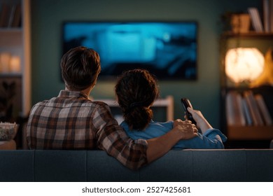 Family watching TV together on sofa