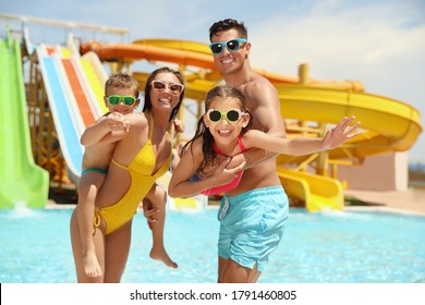 Happy family at water park. Summer vacation