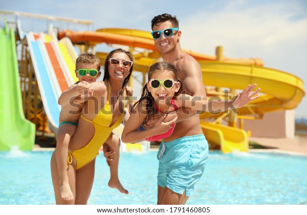 Happy family at\
water park. Summer\
vacation