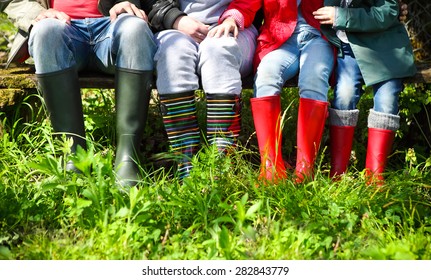 Happy Family Wearing Colorful Rain Boots. Family Concept