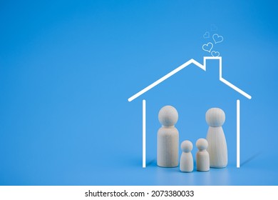 Happy Family. Wooden Doll Family And House With Heart Icon On Blue Background. Copy Space