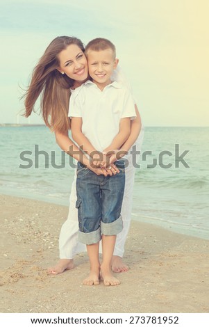 Happy family. Young beautiful  mother and her son having fun on the beach. Positive human emotions, feelings, joy.