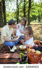 Happy family with young children on a picnic.
 - Shutterstock ID 320040425