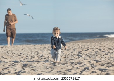 Happy family. Young father throws up baby in the sky on sunny day. Portrait dad and little son on the beach. Positive human emotions feelings emotions. - Powered by Shutterstock