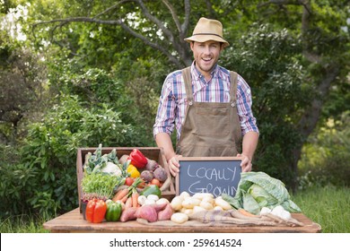 Happy Farmer Showing His Produce On A Sunny Day