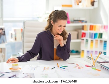 Happy Fashion Designer Working In Office