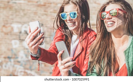 Happy Fashion Friends Watching Videos On Smartphone - Girlfriends Having Fun Social Technology Trends Outdoors - Friendship, Youth Lifestyle, Millennials Generation And Tech Concept