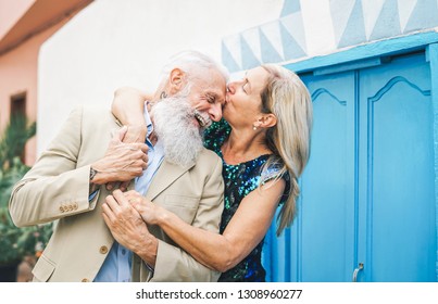 Happy Fashion Senior Couple Dating Outdoor - Mature Elegant Older People Celebrating Date Of Their Anniversary - Wife Kissing Her Husband -  Concept Of Love And Relationship Elderly Lifestyle
