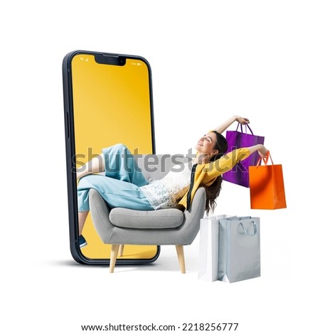 Happy fashionable young woman sitting and holding shopping bags in a smartphone, she is doing online shopping, blank copy space