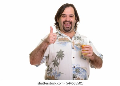 Happy fat Caucasian man smiling while giving thumb up and holding glass of beer ready for vacation isolated against white background