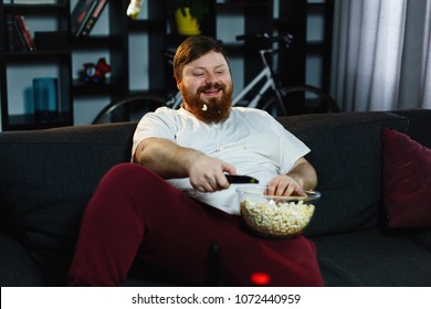 happy-fat-man-eats-popcorn-260nw-1072440959.jpg