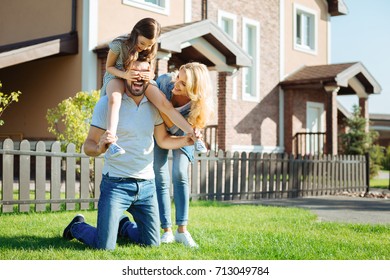 Happy father carrying daughter on his shoulders