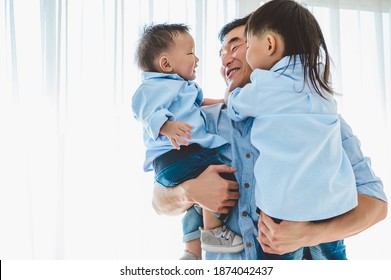 Happy Father Carrying Two Children In Bedroom At Home. Asian Family Living And Having Facial Expression Togetherness. Leisure Time. People Lifestyle Health. Quarantine Covid-19 Coranavirus Theme