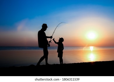 Happy father and child fishermen catch fish by the sea on nature silhouette travel - Powered by Shutterstock