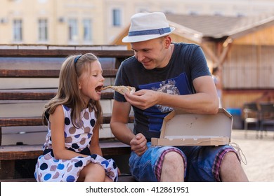 Happy Father And Daughter Eating Pizza Outdoor