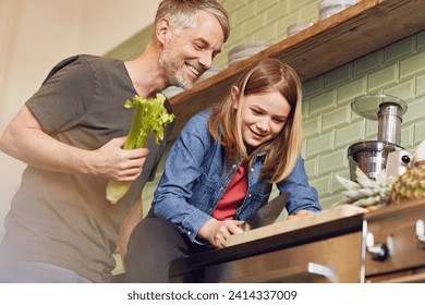 Happy father and daughter in kitchen preparing vegetables - Powered by Shutterstock