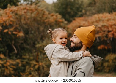 Happy father and daughter playing while walking in a beautiful autumn park. Ideal weekend father with his little daughter. selective focus, noise effect	 - Powered by Shutterstock