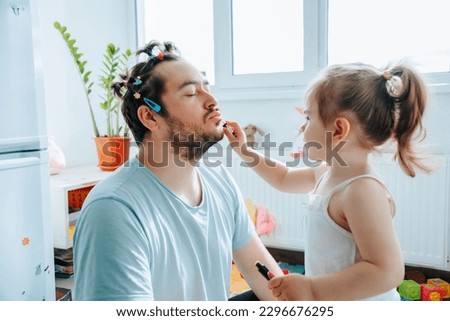 happy father and daughter spending quality time together, with the dad helping his child put on makeup and sharing a laugh. Ultimate Makeover When a Dad Decides to Try Putting Makeup on His Kid