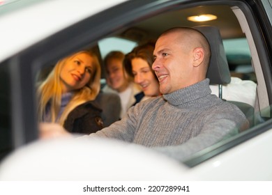 Happy Father Driving A Car Driving His Family To The Holiday Fair