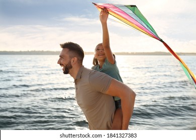 Happy Father And His Child Playing With Kite Near Sea. Spending Time In Nature