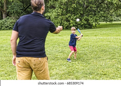 A Happy Father And His Son Playing Baseball