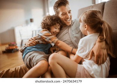 Happy father hugging two kids at home - Powered by Shutterstock