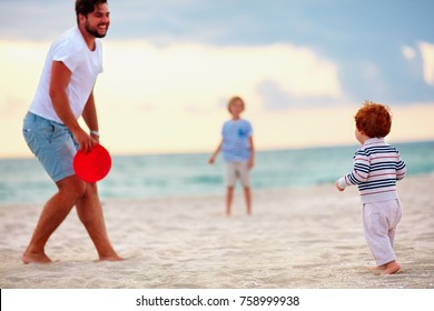 Happy Father With Kids, Family Playing Flying Disc Golf On Evening Beach