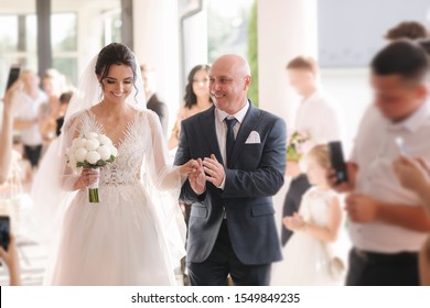 Happy father leading his daughter to the altar. Dad is proud of his beautiful daughter. Wedding ceremony - Shutterstock ID 1549849235