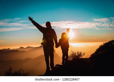 happy father and little daughter travel in mountains at sunset - Shutterstock ID 1280228407