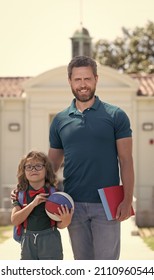 Happy Father With Nerd Son In Glasses Hold Ball And Book First Day At School, Family Values.