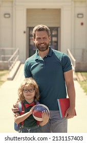 Happy Father With Nerd Son In Glasses Coming Back From First Day At School, Family Support.