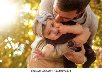 Happy father play with the baby. The man holding the toddler in the hands and have fun laughing,  - Shutterstock ID 2180399273