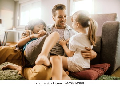 Happy father playing with son and daughter at home - Powered by Shutterstock