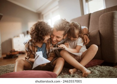 Happy father playing with son and daughter at home - Powered by Shutterstock