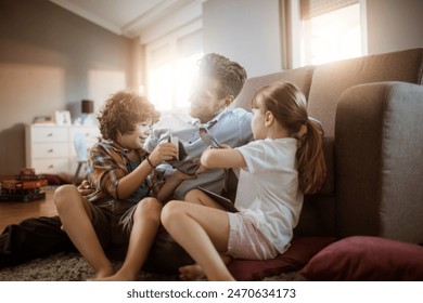 Happy father playing with son and daughter at home - Powered by Shutterstock