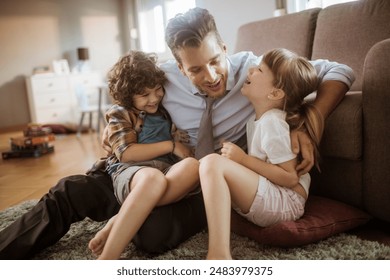 Happy father playing with son and daughter at home - Powered by Shutterstock