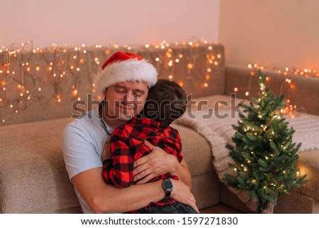 The happy father received a gift from his little son. Christmas concept. Morning before Christmas.