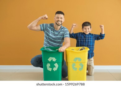 Happy father and son with containers for garbage on color background. Concept of recycling - Powered by Shutterstock