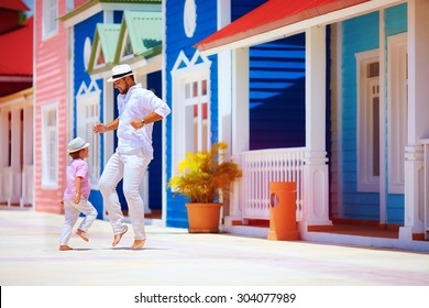 happy father and son enjoy life, dancing on caribbean street