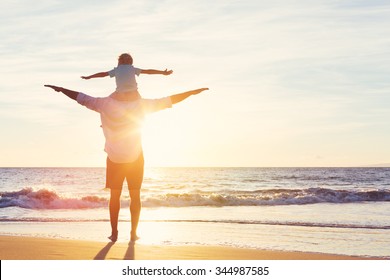 Happy Father and Son Having Fun Playing on the Beach at Sunset. Fatherhood Family Concept