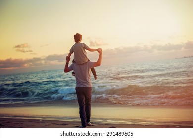 Happy Father And Son Having Quality Family Time On The Beach On Sunset On Summer Holidays. Lifestyle, Vacation, Happiness, Joy Concept