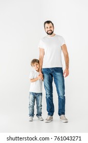 happy father and son holding hands and smiling at camera isolated on white