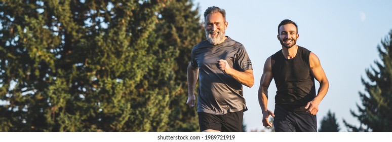 The happy father and a son running on a park road - Powered by Shutterstock