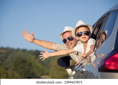 Happy Father And Son Sitting In The Car At The Day Time. They Look Out The Window. People Having Fun Outdoors. Concept Of The Family Is Ready For Travel.