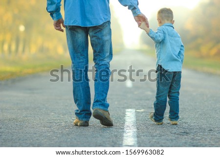 happy father and son walk in nature